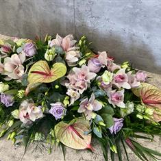 Tropical Anthurium and Cymbidium Orchid casket spray